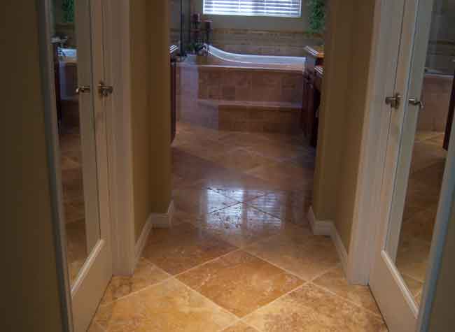 Picture #12 (Bathroom floor) This material is an 18 x 18 chisel edge unfilled travertine with a large range of colors.  A beautiful Tuscan style bathroom was created using this material.